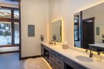 The master bathroom boasts a walk-in shower with custom tile, soaker tub, double vanity, electric toilet & heated floors.